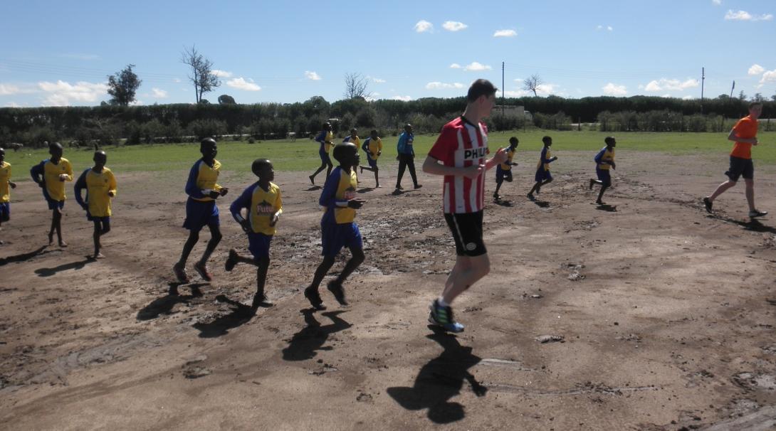 A Projects Abroad volunteer coaching sports with children in Kenya A volunteer teaching sports in Kenya teaches children a quick warm up
